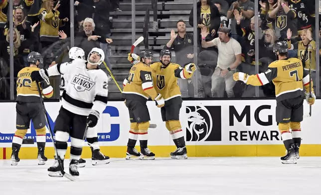 Vegas Golden Knights center Brett Howden (21) and center Tomas Hertl (48) celebrate Hertl's goal against the Los Angeles Kings during the third period of an NHL hockey game Tuesday, Oct. 22, 2024, in Las Vegas. (AP Photo/David Becker)