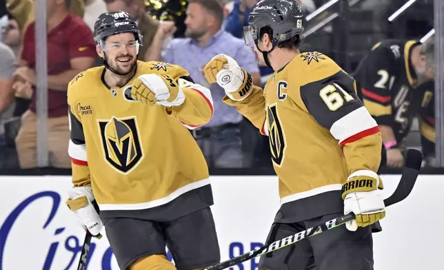 Vegas Golden Knights center Tomas Hertl, left, and right wing Mark Stone (61) celebrate a goal during the first period of an NHL hockey game against the Los Angeles Kings Tuesday, Oct. 22, 2024, in Las Vegas. (AP Photo/David Becker)