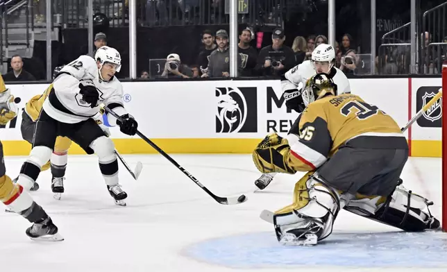 Los Angeles Kings left wing Trevor Moore (12) shoots on Vegas Golden Knights goaltender Ilya Samsonov (35) during the first period of an NHL hockey game Tuesday, Oct. 22, 2024, in Las Vegas. (AP Photo/David Becker)