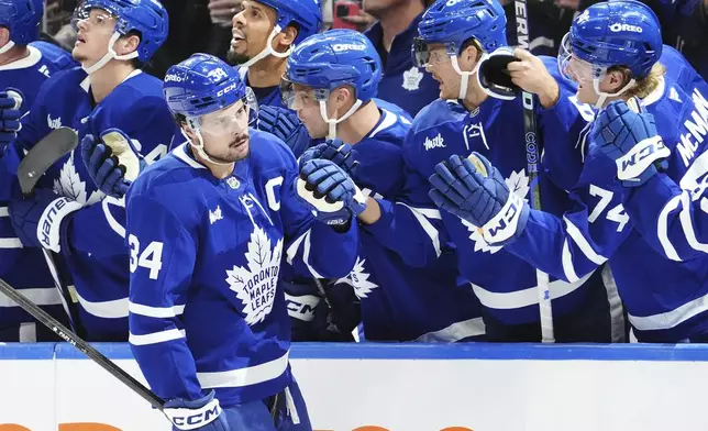 Toronto Maple Leafs' Auston Matthews (34) celebrates his goal against the Los Angeles Kings during the first period of an NHL hockey game, Wednesday, Oct. 16, 2024 in Toronto. (Frank Gunn/The Canadian Press via AP)