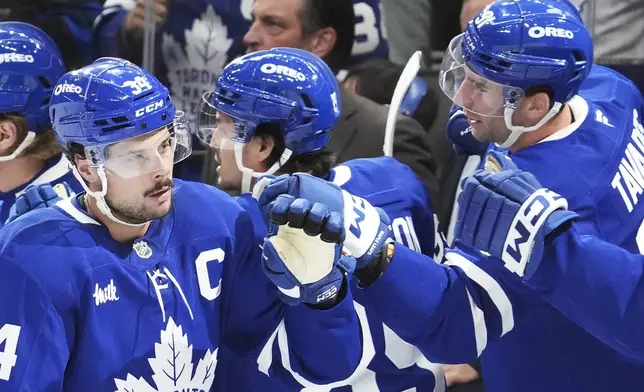 Toronto Maple Leafs' Auston Matthews, left, celebrates his goal against the Los Angeles Kings with John Tavares (91) during the first period of an NHL hockey game, Wednesday, Oct. 16, 2024 in Toronto. (Frank Gunn/The Canadian Press via AP)