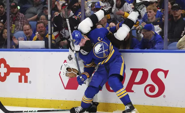 Buffalo Sabres defenseman Rasmus Dahlin (26) checks Los Angeles forward Andre Lee (47) during the second period of an NHL hockey game Thursday, Oct. 10, 2024, in Buffalo, N.Y. (AP Photo/Jeffrey T. Barnes)