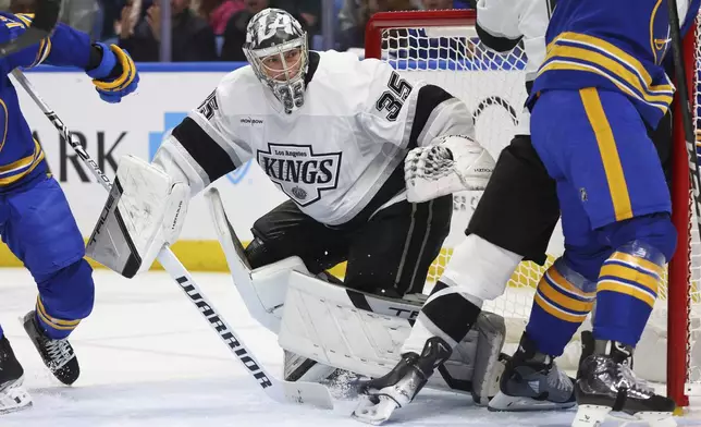 Los Angeles Kings goaltender Darcy Kuemper (35) looks for the puck in traffic during the first period of an NHL hockey game against the Buffalo Sabres, Thursday, Oct. 10, 2024, in Buffalo, N.Y. (AP Photo/Jeffrey T. Barnes)