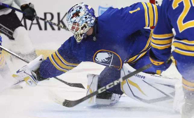 Buffalo Sabres goaltender Ukko-Pekka Luukkonen (1) poke-checks the puck during the second period of an NHL hockey game against the Los Angeles Kings, Thursday, Oct. 10, 2024, in Buffalo, N.Y. (AP Photo/Jeffrey T. Barnes)