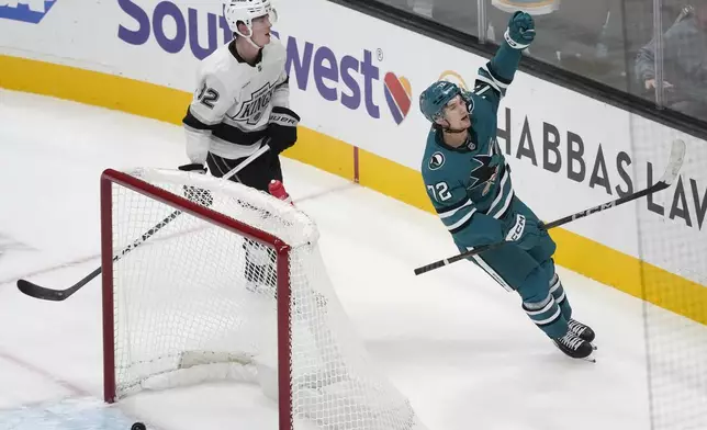 San Jose Sharks left wing William Eklund (72) celebrates after scoring an empty net goal next to Los Angeles Kings defenseman Brandt Clarke during the third period of an NHL hockey game in San Jose, Calif., Tuesday, Oct. 29, 2024. (AP Photo/Jeff Chiu)