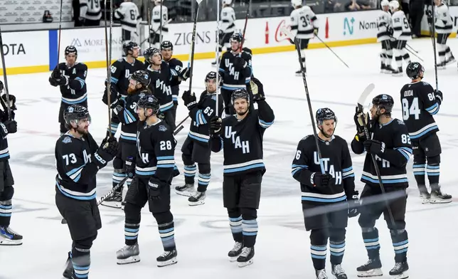 The Utah Hockey Club celebrates their win over the Los Angeles Kings in overtime in a preseason NHL hockey game, Monday, Sept. 23, 2024, in Salt Lake City. (AP Photo/Spenser Heaps)