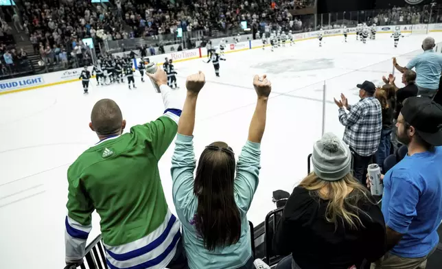 Fans cheer after the Utah Hockey Club beat the Los Angeles Kings in overtime in a preseason NHL hockey game, Monday, Sept. 23, 2024, in Salt Lake City. (AP Photo/Spenser Heaps)