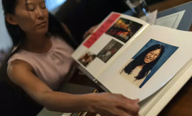 Navy veteran Leah Elmquist shows a childhood photo of her growing up in Nebraska while sifting through mementos in her home, Monday, June 24, 2024, in Las Vegas. She grew up in a white family in a Nebraska town with two stop lights. (AP Photo/David Goldman)