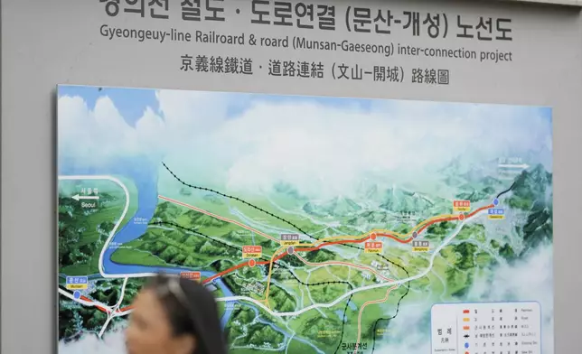 A visitor walks by a map of railroad and road between two Koreas cities, South's Munsan and North's Kaesong, at the Imjingak Pavilion in Paju, South Korea, Tuesday, Oct. 15, 2024. (AP Photo/Lee Jin-man)