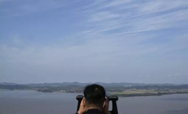 A visitor watches North Korean side from the Unification Observation Post in Paju, South Korea, Wednesday, Oct. 9, 2024. (AP Photo/Lee Jin-man)