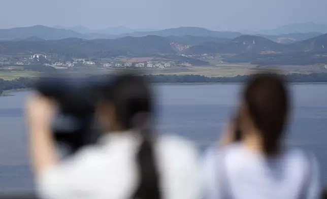 Visitors watch North Korean side from the Unification Observation Post in Paju, South Korea, Wednesday, Oct. 9, 2024. (AP Photo/Lee Jin-man)