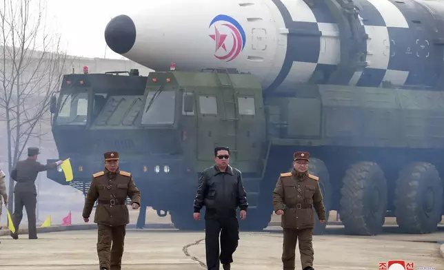 FILE - In this photo distributed by the North Korean government, North Korean leader Kim Jong Un, center, walks near what it says is a Hwasong-17 intercontinental ballistic missile (ICBM) on the launcher at an undisclosed location in North Korea on March 24, 2022. Independent journalists were not given access to cover the event depicted in this image distributed by the North Korean government. The content of this image is as provided and cannot be independently verified. Korean language watermark on image as provided by source reads: "KCNA" which is the abbreviation for Korean Central News Agency. (Korean Central News Agency/Korea News Service via AP, File)