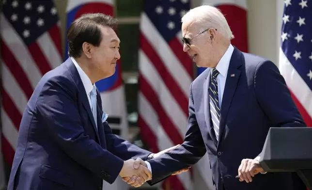 FILE - President Joe Biden, right, and South Korea's President Yoon Suk Yeol shake hands during a news conference in the Rose Garden of the White House, April 26, 2023, in Washington. (AP Photo/Andrew Harnik, File)