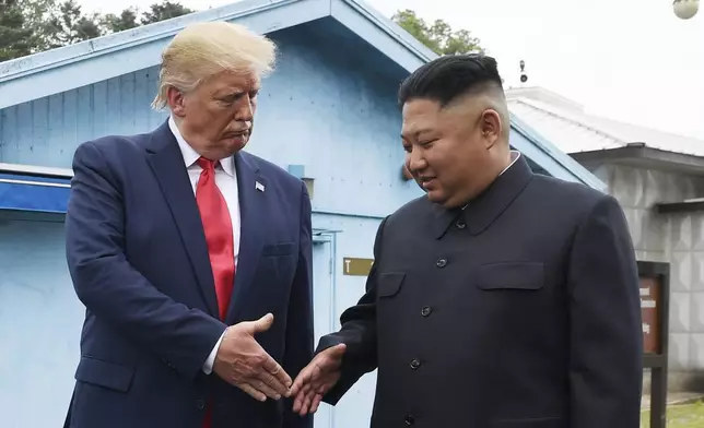 FILE - North Korean leader Kim Jong Un, right, and U.S. President Donald Trump prepare to shake hands at the border village of Panmunjom in the Demilitarized Zone, South Korea, June 30, 2019. (AP Photo/Susan Walsh, File)