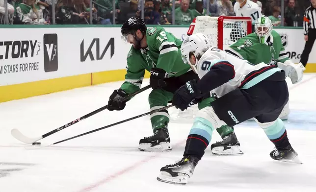 Dallas Stars center Colin Blackwell (15) and Seattle Kraken center Chandler Stephenson (9) battle for the puck in the second period during an NHL hockey game on Sunday, Oct. 13, 2024, in Dallas. (AP Photo/Richard W. Rodriguez)