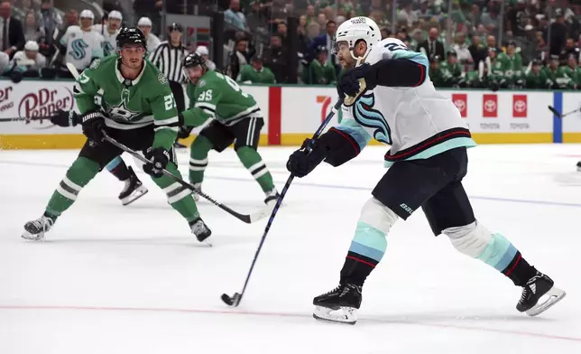 Seattle Kraken right wing Oliver Bjorkstrand (22) shoots against the Dallas Stars in the second period during an NHL hockey game on Sunday, Oct. 13, 2024, in Dallas. (AP Photo/Richard W. Rodriguez)