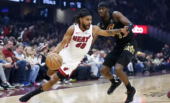 FILE - Miami Heat guard Patty Mills (88) drives against Cleveland Cavaliers guard Caris LeVert (3) during the first half of an NBA basketball game, March 20, 2024, in Cleveland. (AP Photo/Ron Schwane, File)