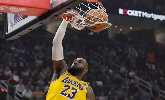 Los Angeles Lakers forward LeBron James (23) dunks in the first half of an NBA basketball game against the Cleveland Cavaliers, Wednesday, Oct. 30, 2024, in Cleveland. (AP Photo/Sue Ogrocki)