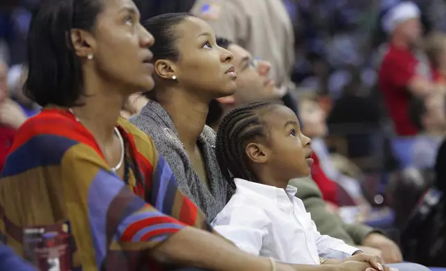 FILE - LeBron James Jr., right, watches the Cleveland Cavaliers play the Miami Heat with his mother, Savannah Brinson, center, and grandmother Gloria James, left, during an NBA basketball game Tuesday, Dec. 25, 2007, in Cleveland. (AP Photo/Mark Duncan, File)