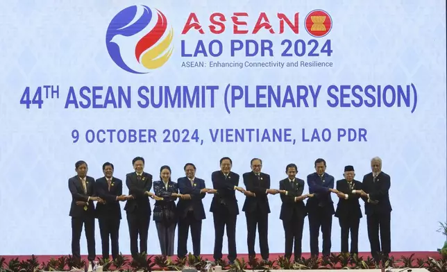 From left to right, Foreign Ministry Permanent Secretary Aung Kyaw Moe, Philippine's President Ferdinand Marcos Jr., Singaporean Prime Minister Lawrence Wong, Thailand Prime Minister Paetongtarn Shinawatra, Vietnamese Prime Minister Pham Minh Chinh, Laos' Prime Minister Sonexay Siphandone, Malaysia Prime Minister Anwar Ibrahim, Brunei Sultan Hassanal Bolkiah, Cambodian Prime Minister Hun Manet, Indonesian Vice President Ma'ruf Amin, and East Timorese Prime Minister Xanana Gusmao hold hands during the opening ceremony of the Association of South East Asian Nations (ASEAN) 44th Summit in Vientiane, Laos, Wednesday, Oct. 9, 2024. (Sakchai Lalit)