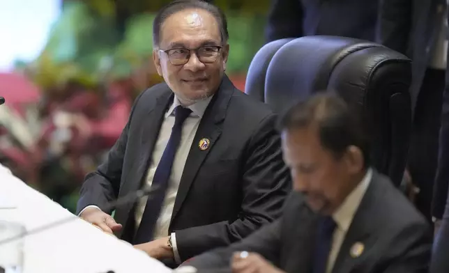 Malaysia Prime Minister Anwar Ibrahim, right, attends the 44th the Association of Southeast Asian Nations (ASEAN) Minister in Vientiane, Laos, Wednesday, Oct. 9, 2024. (AP Photo/Sakchai Lalit)