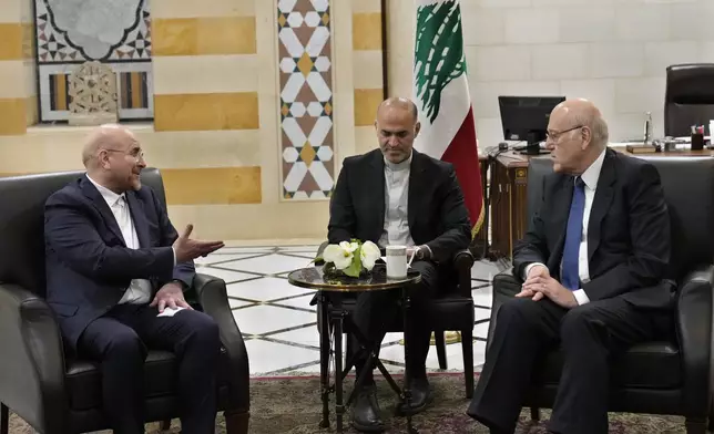 Lebanese caretaker Prime Minister Najib Mikati, right, meets with Iran's parliament speaker Mohammad Bagher Qalibaf, in Beirut, Lebanon, Saturday, Oct. 12, 2024. (AP Photo/Hussein Malla)