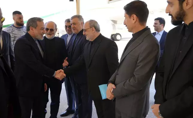 In this photo released by Iranian Foreign Ministry, Foreign Minister Abbas Araghchi, left, is welcomed by a group of officials upon arrival at Beirut, Lebanon, Friday, Oct. 4, 2024. (Iranian Foreign Ministry via AP)