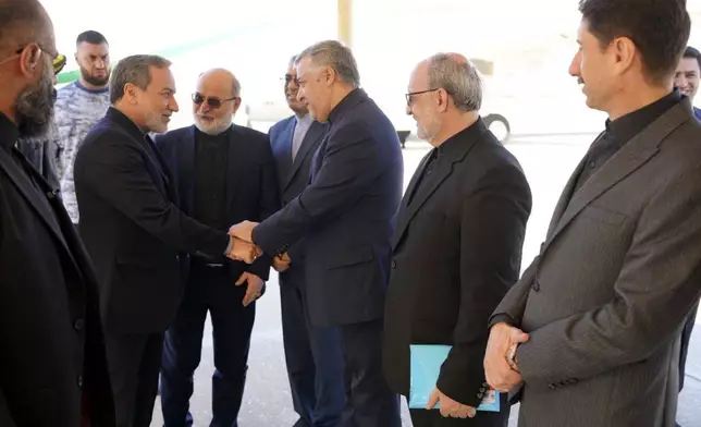 In this photo released by Iranian Foreign Ministry, Iranian Foreign Minister Abbas Araghchi, left, is welcomed by a group of officials upon arrival at Beirut, Lebanon, Friday, Oct. 4, 2024. (Iranian Foreign Ministry via AP)