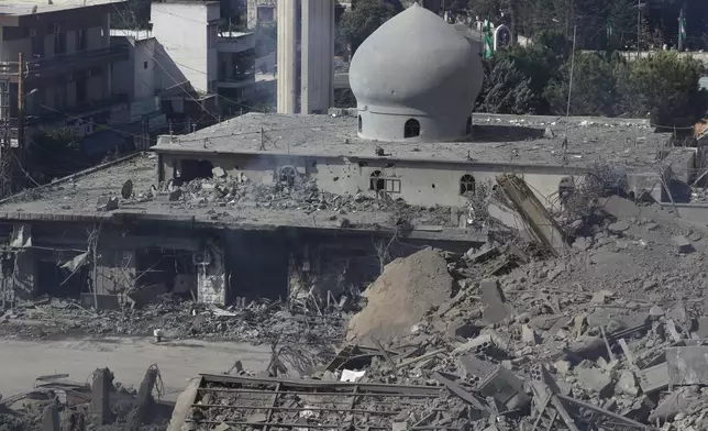 Destroyed shops and a mosque are seen on a commercial street that was hit Saturday night by Israeli airstrikes, in Nabatiyeh town, south Lebanon, Sunday, Oct. 13, 2024. (AP Photo/Mohammed Zaatari)