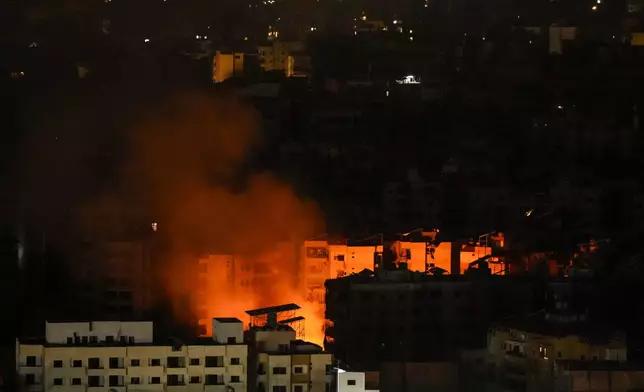 Smoke and fire rise from the site of an Israeli airstrike in Dahiyeh, Beirut, Lebanon, Tuesday, Oct. 8, 2024. (AP Photo/Hassan Ammar)