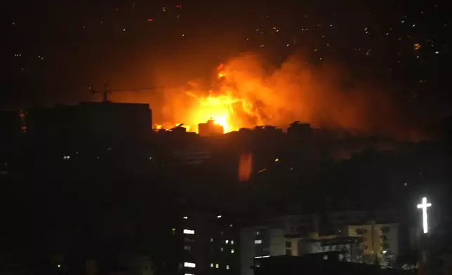 Flames and smoke rise from an Israeli airstrike in Dahiyeh, Beirut, Lebanon, early Sunday, Oct. 6, 2024. (AP Photo/Hussein Malla)