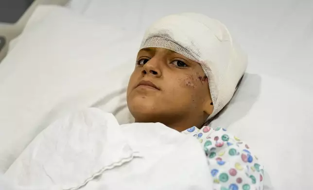 A girl who was wounded in an Israeli airstrike, lies in Rayak Hospital, in the village of Rayak, Bekaa Valley, eastern Lebanon, Saturday, Oct. 5, 2024. (AP Photo/Hassan Ammar)