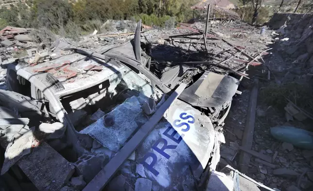 Destroyed vehicles used by journalists at the site where an Israeli airstrike hit a compound housing journalists, killing three media staffers from two different news agencies according to Lebanon's state-run National News Agency, in Hasbaya village, southeast Lebanon, Friday, Oct. 25, 2024. (AP Photo/Mohammed Zaatari)