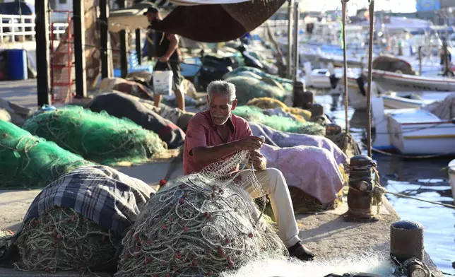 Saber al-Sayyad, a Lebanese fisherman, checks his nets after the Israeli army ordered fishermen and people using any kinds of boats not to sail along an area over 50 kilometers (31 miles) from the Israeli border, in the southern port city of Sidon, Lebanon, Tuesday, Oct. 8, 2024. (AP Photo/Mohammed Zaatari)