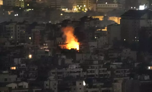 Flame rise from a building that was hit by an Israeli airstrike on Dahiyeh, in the southern suburb of Beirut, Lebanon, Sunday, Oct. 20, 2024. (AP Photo/Hussein Malla)