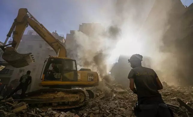 Rescue workers search for victims at the site of Thursday's Israeli airstrike in Beirut, Lebanon, Friday, Oct. 11, 2024. (AP Photo/Hassan Ammar)