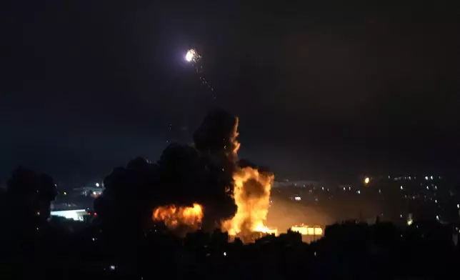 Flames rise from Israeli airstrikes in Dahiyeh, Beirut, Lebanon, Friday, Oct. 4, 2024. (AP Photo/Hussein Malla)