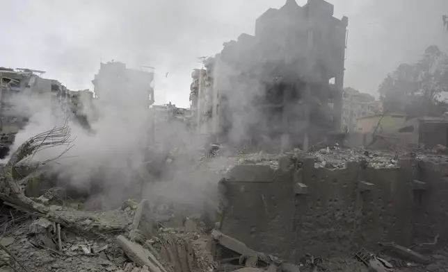 Smoke rises from destroyed buildings at the site of an Israeli airstrike hit in Choueifat, southeast of Beirut, Lebanon, Monday, Oct. 7, 2024. (AP Photo/Bilal Hussein)