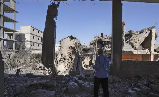 A man checks his damaged house at the site of an Israeli airstrike in Baalbek, east Lebanon, Monday, Oct. 7, 2024. (AP Photo/Hassan Ammar)