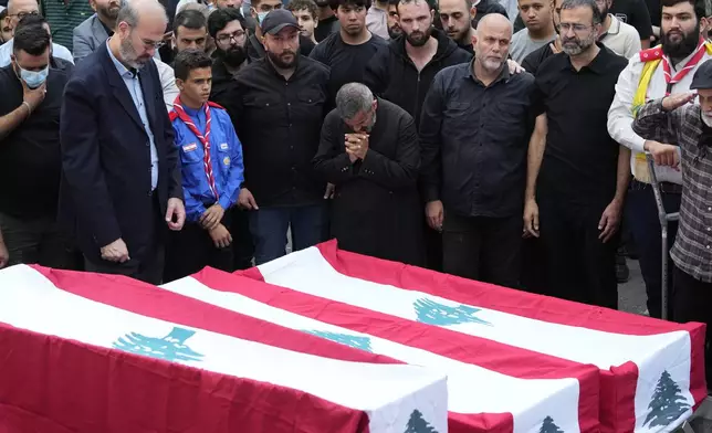 People mourn over the coffins of their relatives, killed on Saturday in an Israeli airstrike, during their funeral procession in Maisara near the northern coastal town of Byblos, Lebanon, Monday, Oct. 14, 2024. (AP Photo/Hassan Ammar)