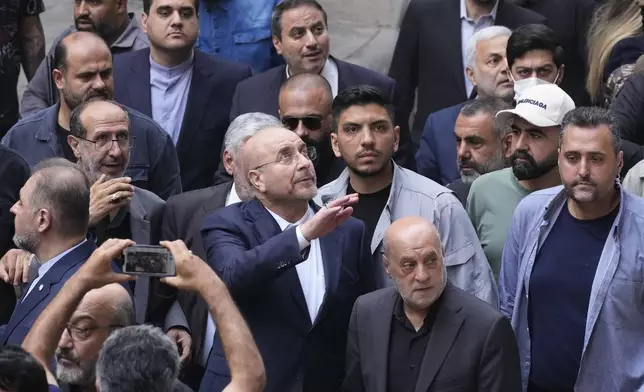 Iran's parliament speaker Mohammad Bagher Qalibaf, center, visits the site of Thursday's Israeli airstrike in Beirut, Lebanon, Saturday, Oct. 12, 2024. (AP Photo/Hassan Ammar)