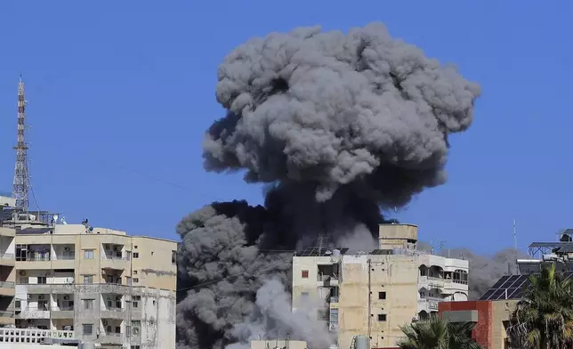 Smoke rises from buildings hit in an Israeli airstrike in Tyre, Lebanon, Wednesday, Oct. 23, 2024. (AP Photo/Mohammad Zaatari)