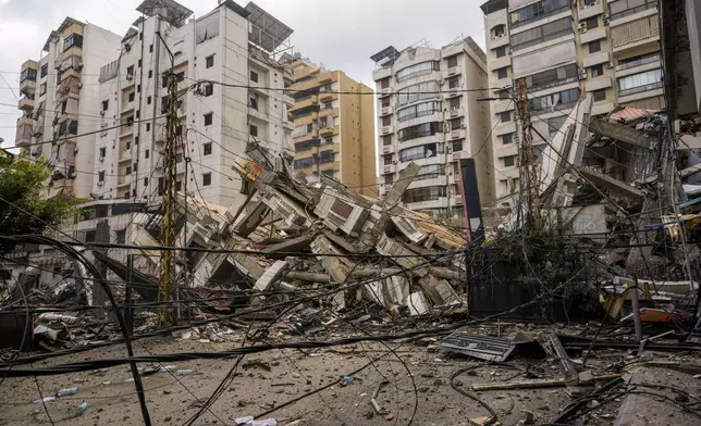 A damaged building is seen at the site of an Israeli airstrike in Beirut's southern suburb, Lebanon, Tuesday, Oct. 1, 2024. (AP Photo/Hassan Ammar)