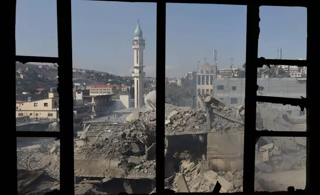 Destroyed buildings at a commercial street that was hit Saturday night by Israeli airstrikes, are seen in Nabatiyeh town, south Lebanon, Sunday, Oct. 13, 2024. (AP Photo/Mohammed Zaatari)