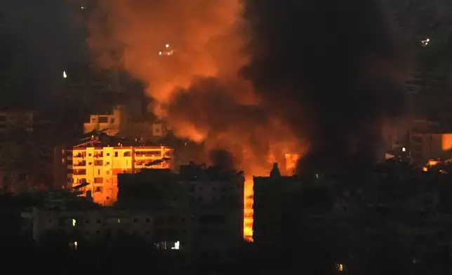 Flame and smoke rises from buildings hit by Israeli airstrikes on Dahiyeh, in the southern suburb of Beirut, Lebanon, early Sunday, Oct. 27, 2024. (AP Photo/Hussein Malla)