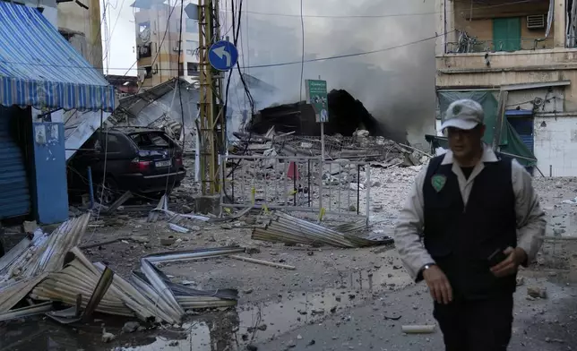 A man leaves a street after he saw the building where he was living and destroyed by Israeli airstrike in Dahiyeh, Beirut, Lebanon, Sunday, Oct. 6, 2024. (AP Photo/Hussein Malla)