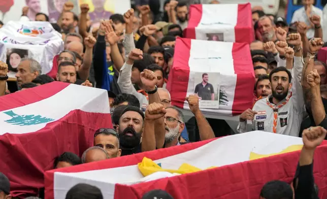 Mourners carry the coffins of their relatives, killed on Saturday in an Israeli airstrike, during their funeral procession in Maisara near the northern coastal town of Byblos, Lebanon, Monday, Oct. 14, 2024. (AP Photo/Hassan Ammar)