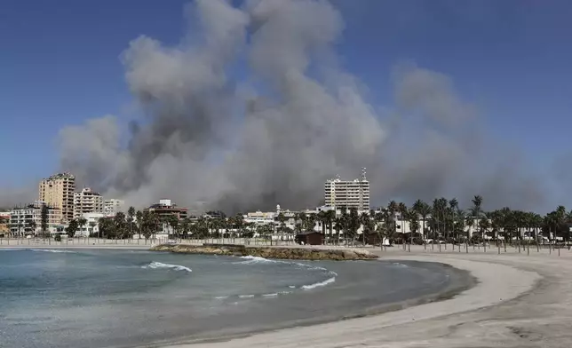 Smoke rises from buildings hit in Israeli airstrikes in Tyre, Lebanon, Wednesday, Oct. 23, 2024. (AP Photo/Mohammad Zaatari)