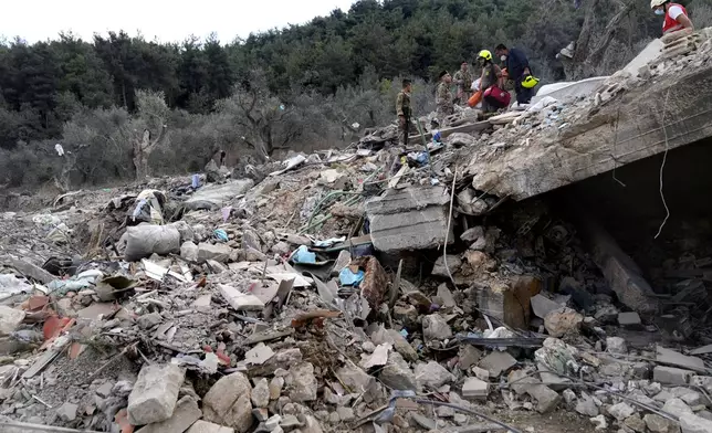 Search continues among the rubble of a destroyed building at the site of Monday's Israeli airstrike in Aito village, north Lebanon, Tuesday, Oct. 15, 2024. (AP Photo/Hussein Malla)