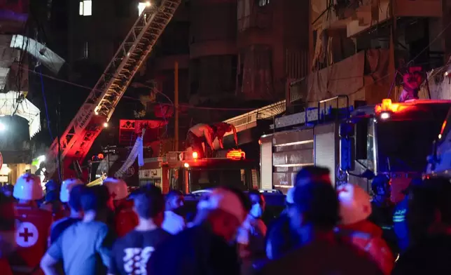 Paramedics and rescue workers work at the site of an Israeli airstrike in Beirut, Lebanon, Thursday, Oct. 10, 2024. (AP Photo/Hassan Ammar)